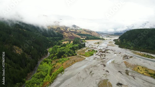 Scenic road on river bank in Wairau valley, New Zealand on cloudy day after rain photo
