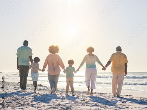 Family on the beach, holding hands and generations, travel and summer vacation, solidarity and love outdoor. Grandparents, parents and children on holiday, people together with back view in Cancun