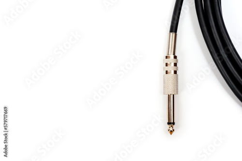 Long black jack cord for electric guitar, filmed on a white background.