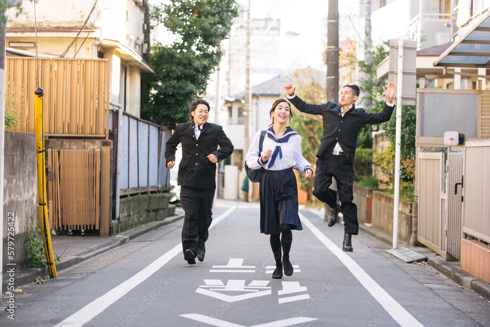 Young japanese students with traditional school college uniforms meeting outdoors in Tokyo - Happy asian friends bonding in the city after school