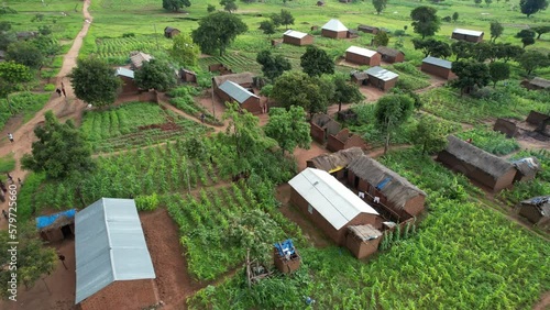 Aerial view to rural village in Africa. Mud huts and agricultural land. Local people living in small communities in Tanzania photo