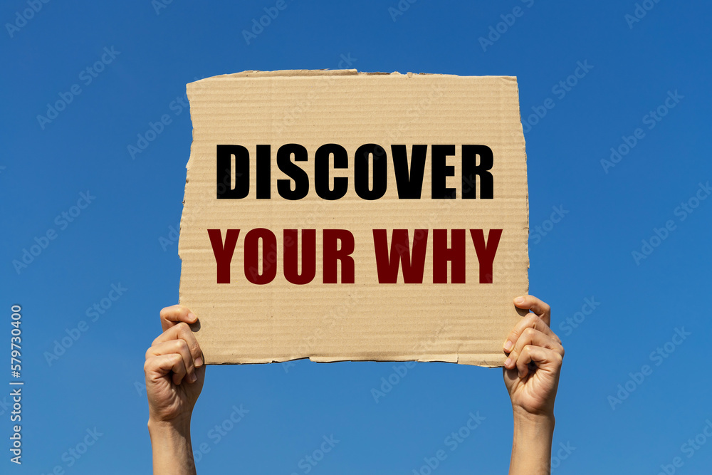 Discover your why text on box paper held by 2 hands with isolated blue sky background. This message board can be used as business concept about discovering your why. Discover your why text on box paper held by 2 hands with isolated blue sky background. This message board can be used as business concept about discovering your why.