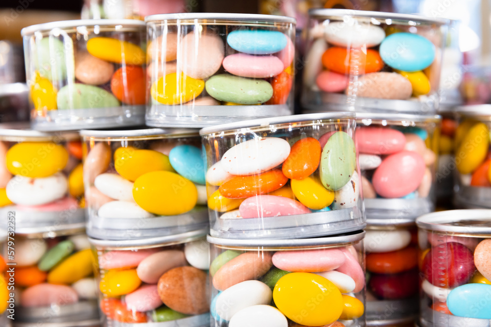 Dragee Candies in stacked transparent plastic jars Dragee Candies in stacked transparent plastic jars