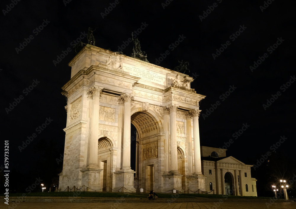 the Arch of the peace - Old door of the city - Historical entrance in the city - Two symbols of Milan Sempione district at night.