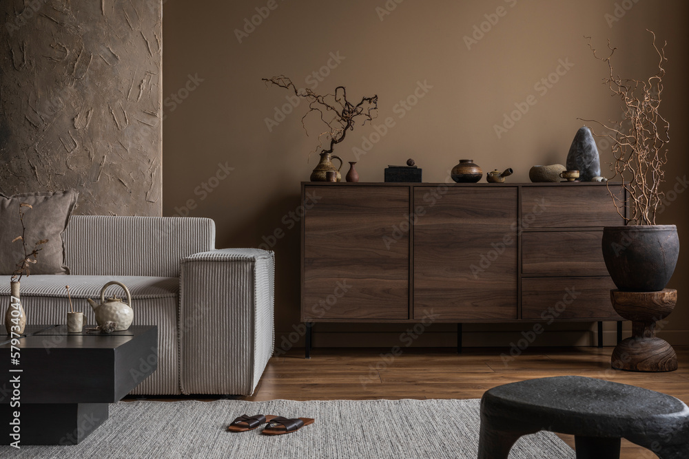 Aesthetic composition of wabi sabi living room interior with mock up poster, modular sofa, wooden commode, rug, stylish coffee table, vase with branch and personal accessories. Home decor. Template. - obrazy, fototapety, plakaty 