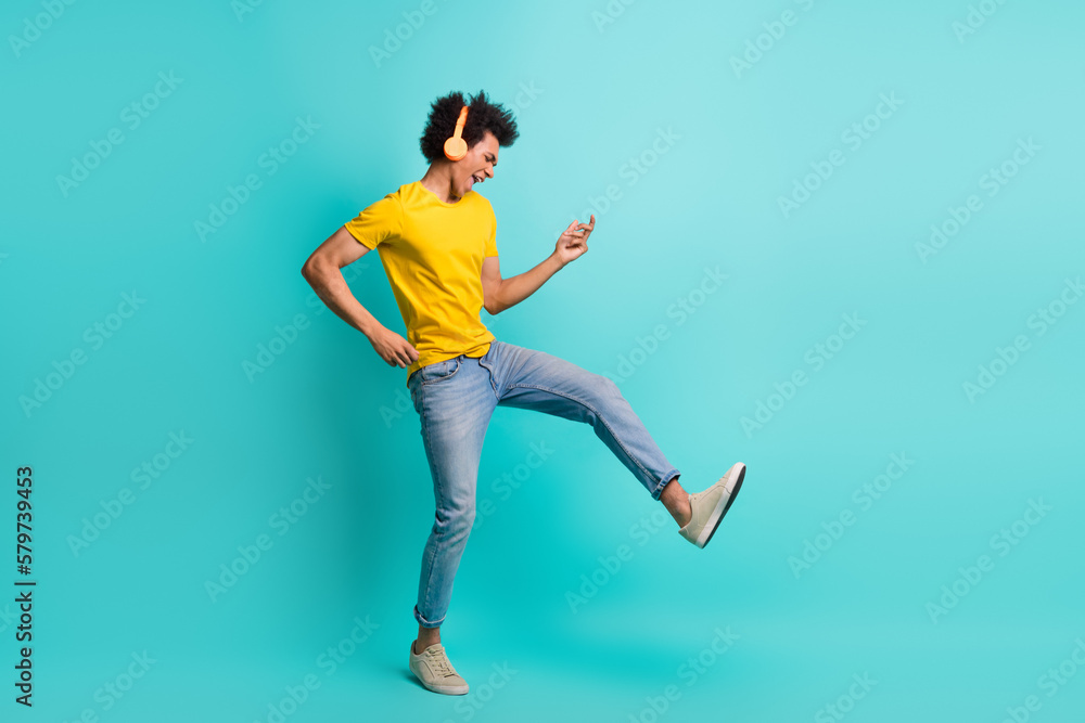 Full body portrait of crazy positive person arms play imagine guitar listen music headphones isolated on turquoise color background Full body portrait of crazy positive person arms play imagine guitar listen music headphones isolated on turquoise color background