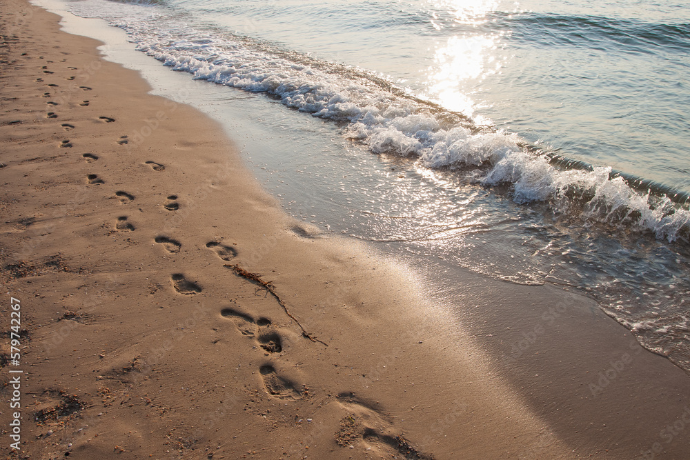 Footprint on the sea beach. Sunrise over the sea. Black Sea. Small depth of field. Small depth of field. Marine theme Footprint on the sea beach. Sunrise over the sea. Black Sea. Small depth of field. Small depth of field. Marine theme