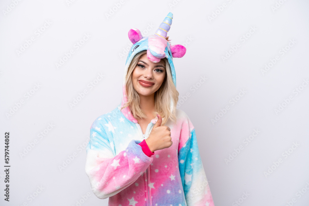 Young Russian woman with unicorn pajamas isolated on white background giving a thumbs up gesture Young Russian woman with unicorn pajamas isolated on white background giving a thumbs up gesture