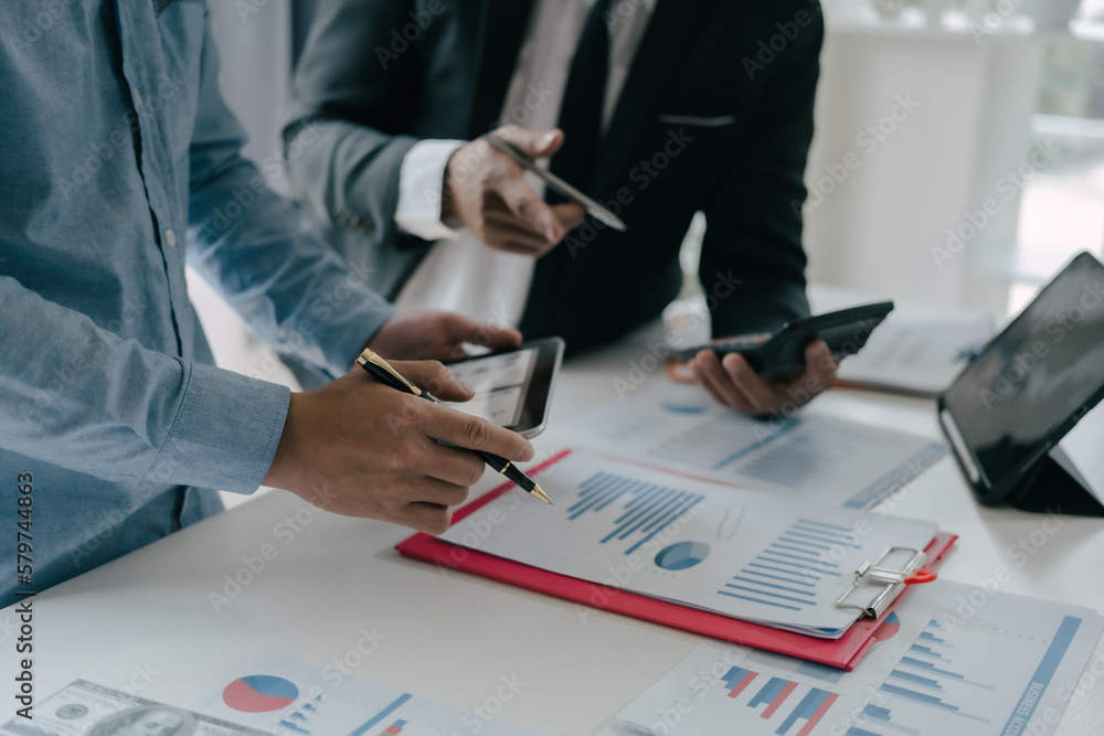 Business people are deeply examining financial reports for investment returns or investment risk analysis. Business people are deeply examining financial reports for investment returns or investment risk analysis.