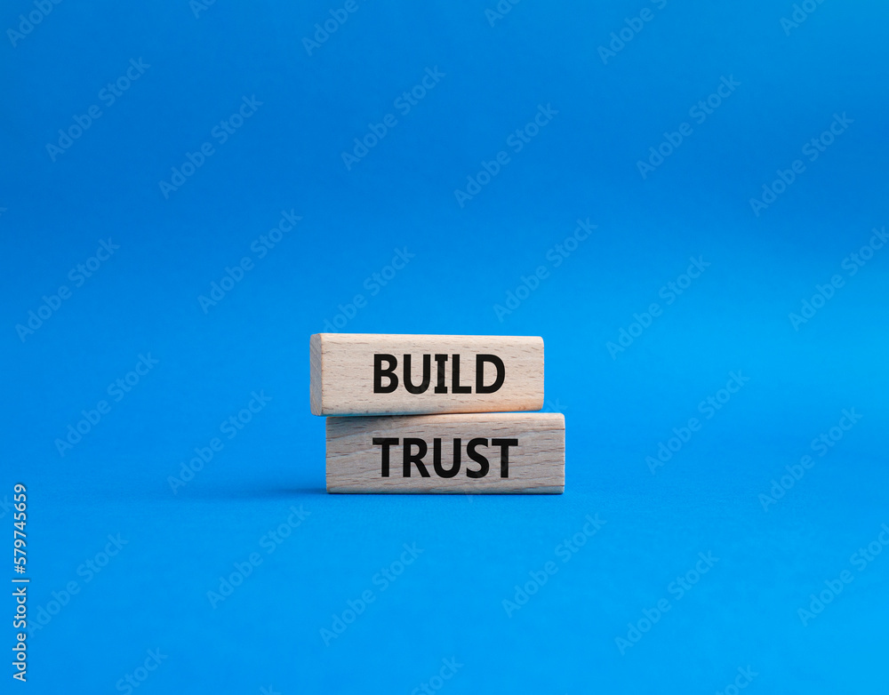 Build trust symbol. Wooden blocks with words Build trust. Beautiful blue background. Business and Build trust concept. Copy space. Build trust symbol. Wooden blocks with words Build trust. Beautiful blue background. Business and Build trust concept. Copy space.