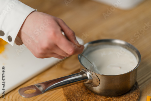Cheese sauce for a burger in a pan close-up of a professional kitchen gastronomy