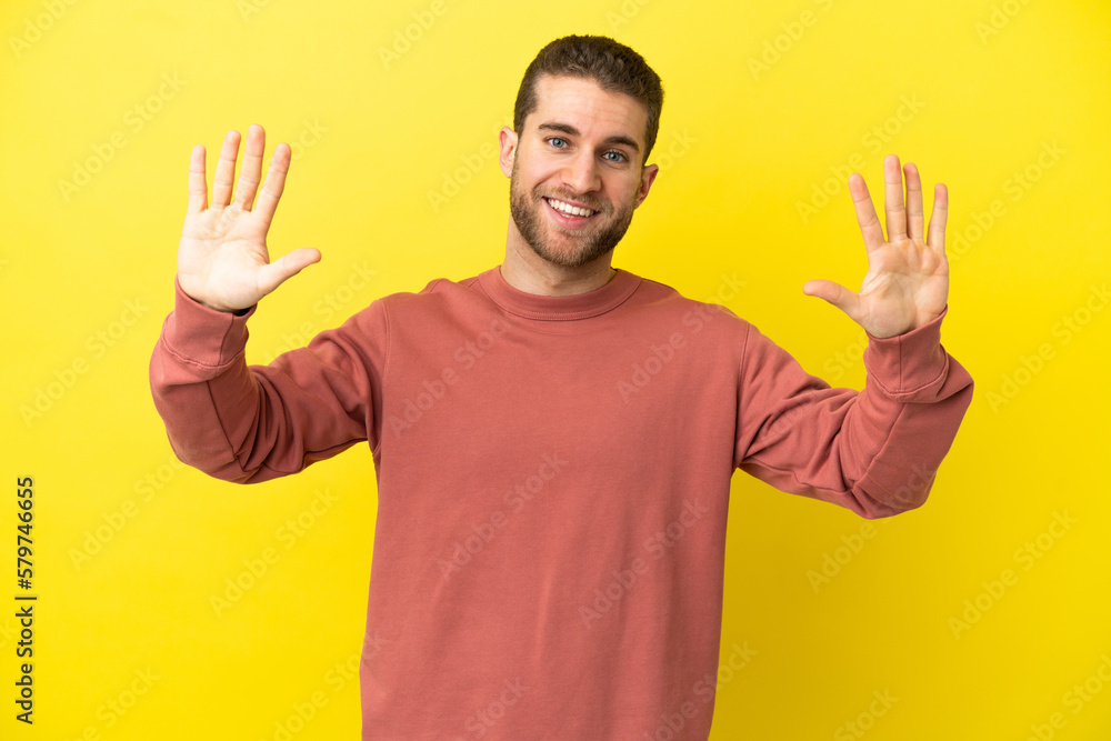 Handsome blonde man over isolated yellow background counting ten with fingers Handsome blonde man over isolated yellow background counting ten with fingers