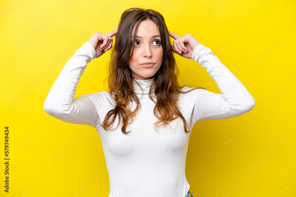 Young caucasian woman isolated on yellow background having doubts and thinking Young caucasian woman isolated on yellow background having doubts and thinking