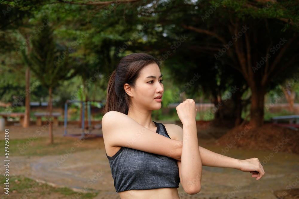 Portrait of beautiful young woman exercising in the park. Caucasian female fitness model working out in the morning. Portrait of beautiful young woman exercising in the park. Caucasian female fitness model working out in the morning.