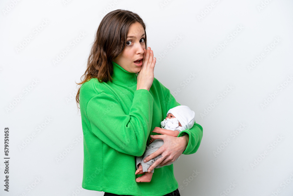 Young caucasian woman with her cute baby isolated on white background whispering something Young caucasian woman with her cute baby isolated on white background whispering something