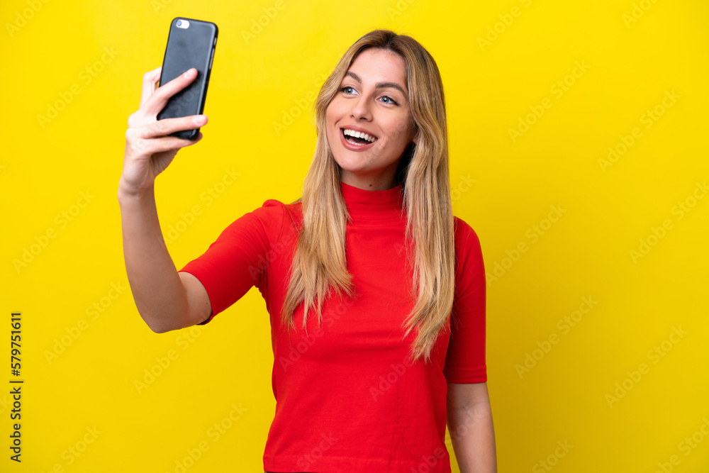 Young Uruguayan woman isolated on yellow background making a selfie Young Uruguayan woman isolated on yellow background making a selfie