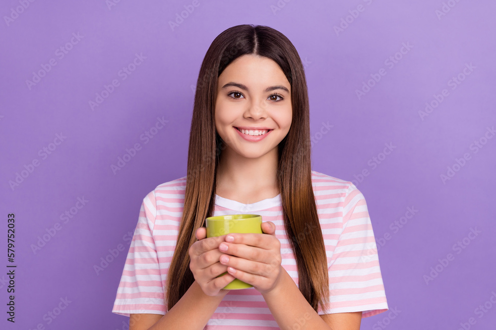 Photo of cute charming girl dressed striped t-shirt enjoying hot tasty beverage isolated purple color background Photo of cute charming girl dressed striped t-shirt enjoying hot tasty beverage isolated purple color background