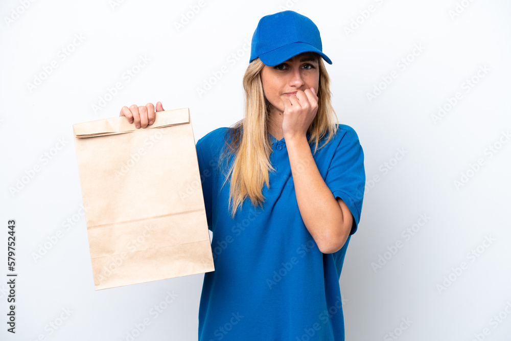 Young Uruguayan woman taking a bag of takeaway food isolated on white background having doubts Young Uruguayan woman taking a bag of takeaway food isolated on white background having doubts