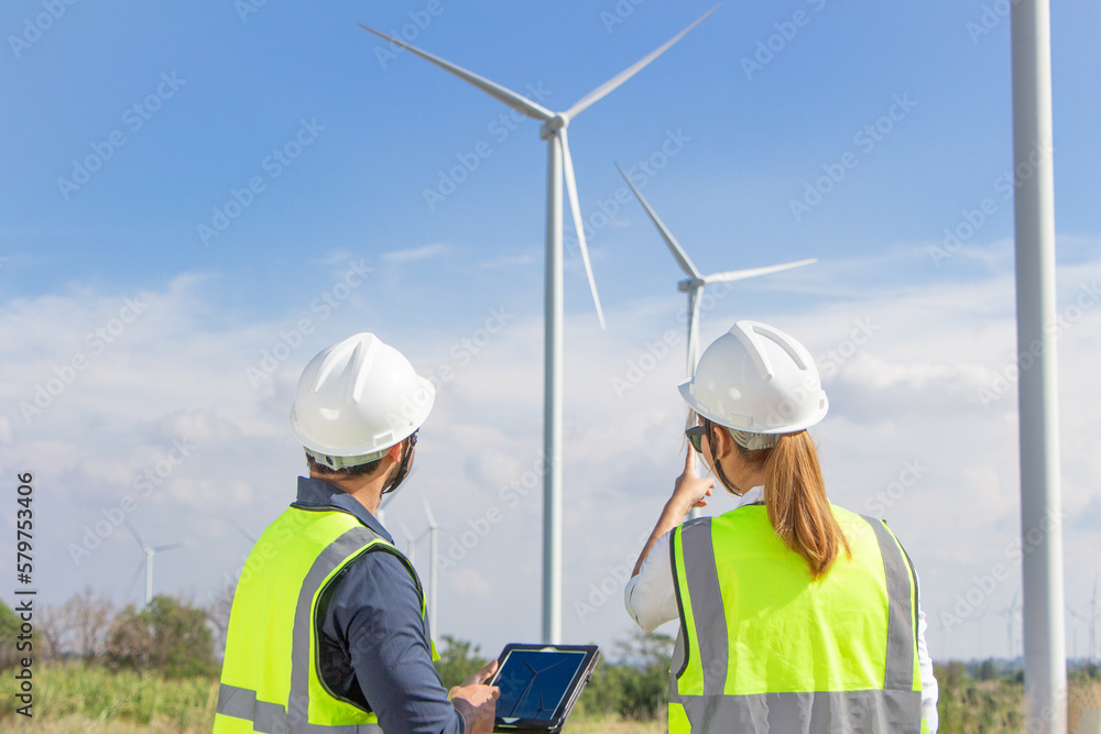 engineer team working in wind turbine farm. Renewable energy with wind generator by alternative energy concept. engineer team working in wind turbine farm. Renewable energy with wind generator by alternative energy concept.
