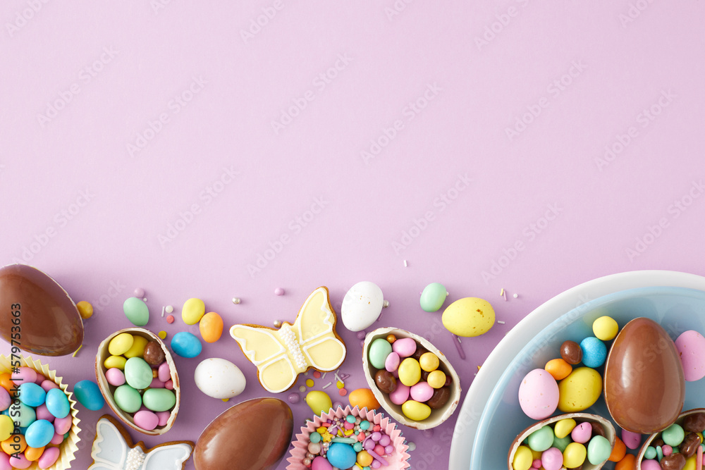 Easter sweets concept. Top view photo of chocolate eggs in blue plate dragees gingerbread and sprinkles on isolated pastel violet background with empty space. Holiday decoration idea