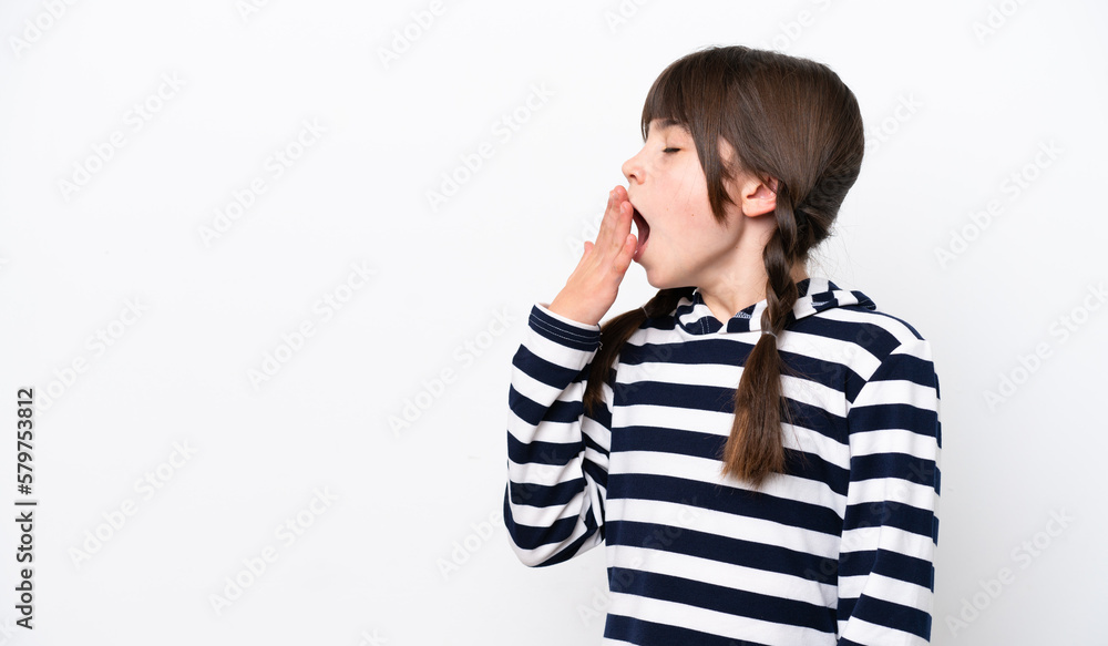 Little caucasian girl isolated on white background yawning and covering wide open mouth with hand Little caucasian girl isolated on white background yawning and covering wide open mouth with hand