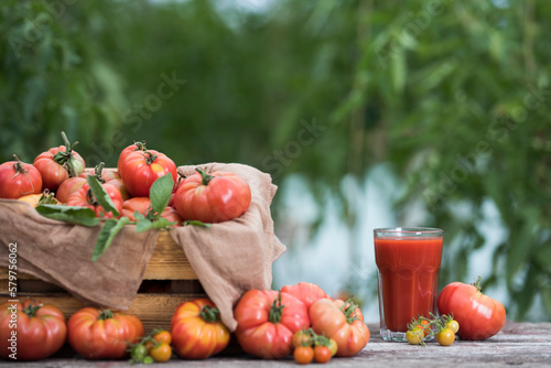 Fresh tomato juice, on a wooden background