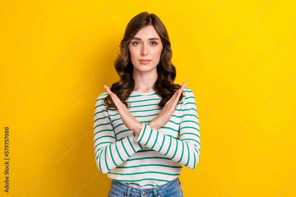 Photo of pretty lovely girlish woman with curly hairstyle wear striped shirt hold arms crossed isolated on yellow color background Photo of pretty lovely girlish woman with curly hairstyle wear striped shirt hold arms crossed isolated on yellow color background