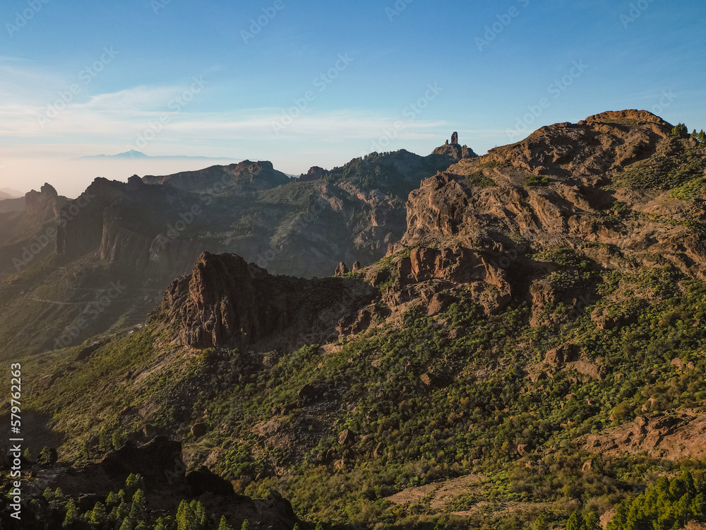 Aerial View of Rocky Mountains with Roque Nublo and Mount Teide in the Background in Gran Canaria, Spain