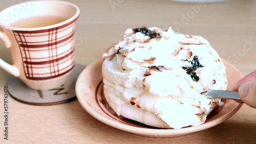 Homemade mini meringue with cream, delicious dessert. Eating a piece of cake with cream