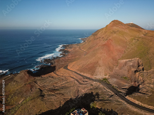 Aerial view of mountain and road next to rocky shoreline in La Isleta, Las Palmas de Gran Canaria, Spain