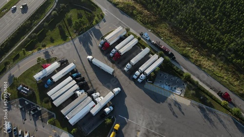 Aerial view of trucks lined up near a gas station.