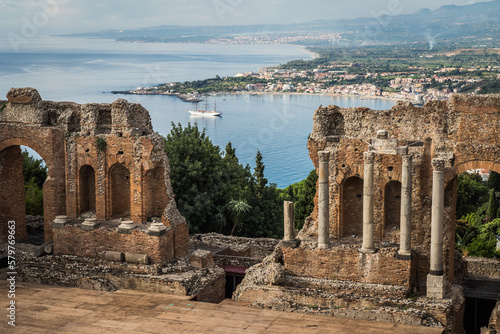 Tableau sur toile Ancient town Taormina in Sicily, Italy with antique theatre in Mediterranean and