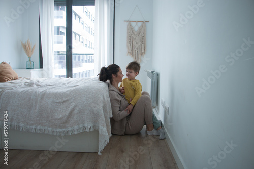 Baby boy toddler cheering up his mom