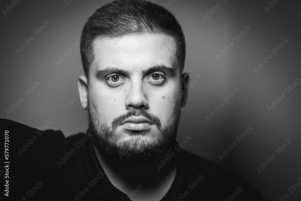 Grayscale portrait of a young Caucasian male with a serious face Grayscale portrait of a young Caucasian male with a serious face