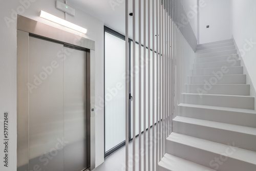 Modern high-tech style in the entrance of a new house or office building with an elevator  staircase and panoramic window. Concept of new buildings with a developed modern structure