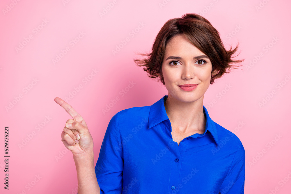 Photo of pretty lovely lady direct finger empty space useful tips isolated on pink color background Photo of pretty lovely lady direct finger empty space useful tips isolated on pink color background