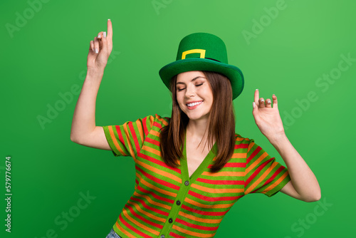 Photo of positive pretty lady toothy smile closed eyes point fingers enjoy dancing isolated on green color background