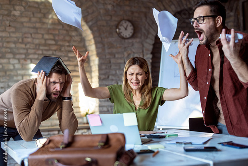 Tableau sur toile Stressful situation in office, business people working and receiving bad news