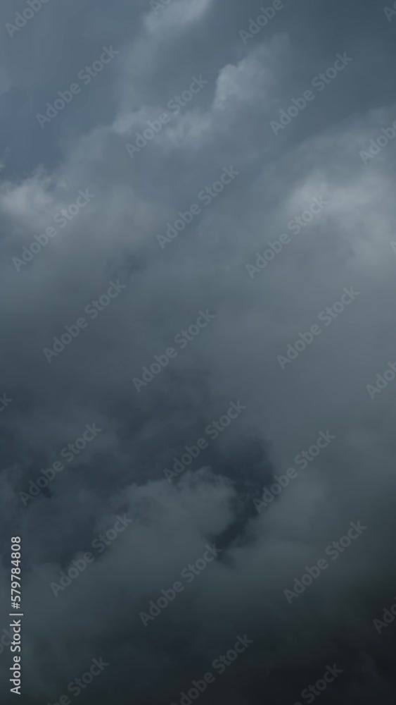 Dramatic dark storm clouds are moving fast. Vertical video Dramatic dark storm clouds are moving fast. Vertical video