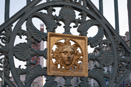A golden face: detail of the original metal fence of the Royal Palace of Turin, Italy.