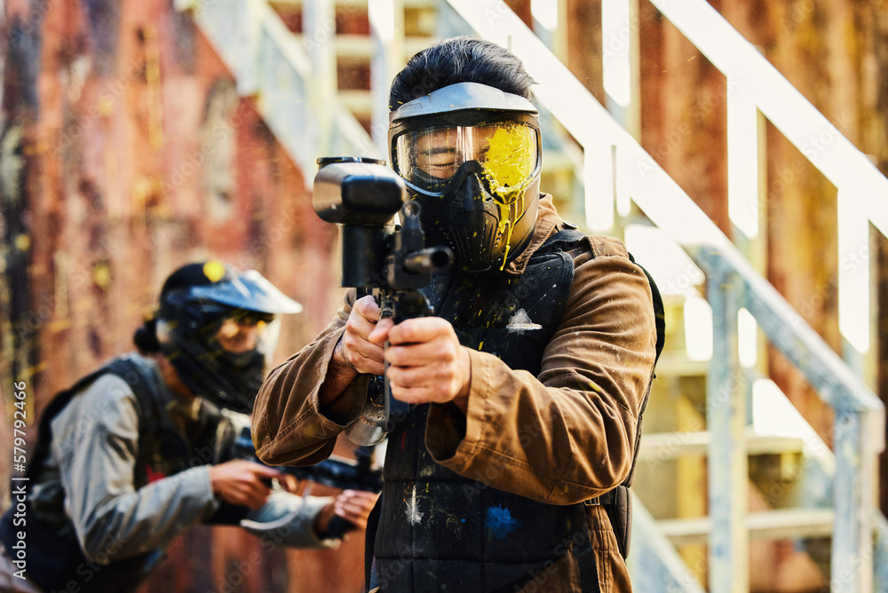 Φωτογραφία Paintball, person shot with paint and gun, helmet for safety on shooting range and war game for sports