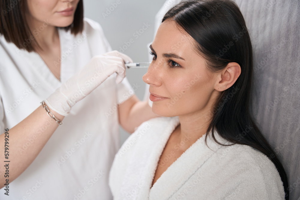 Medic doing cosmetic procedures to client, skin nutrition Medic doing cosmetic procedures to client, skin nutrition