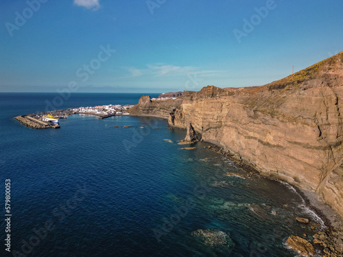 Aerial view of beach and port in traditional whitewashed village, Puerto de las Nieves, Agaete, with cliffs in the northern coast of Gran Canaria, Spain