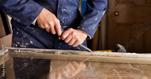 Fotografi Restoration of old sash windows -  wooden frames are scraped from old patty and paint