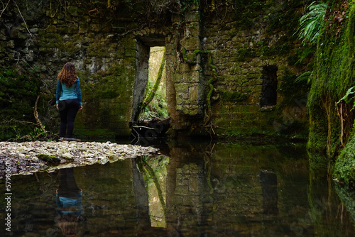 Hiker girl nearby the ancient grindstone of Biedano gorges, Barbarano Romano, Viterbo, Lazio, Italy