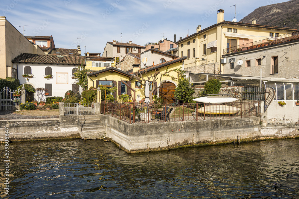 beautiful houses reflecting on the water of the lake on the lakefront of Salò