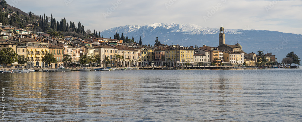 Extra wide view of The beautiful lakeside of Salò with the Lake Garda and the Monte Baldo in background