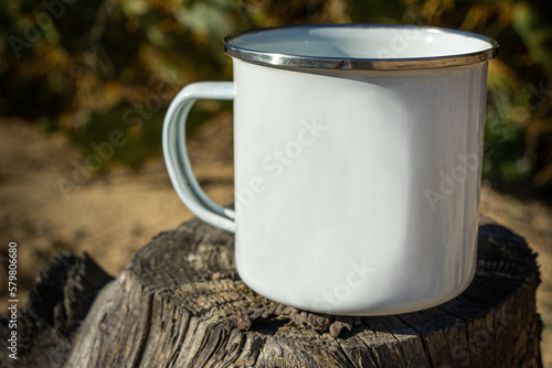 White metal cup mockup on tree