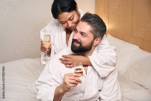 Cheerful couple drinking together to their anniversary