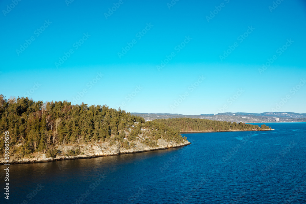 Small island next to a fjord in Norway. Small white houses on a small island in the North Sea. Beautiful life in nature, in Scandinavia	